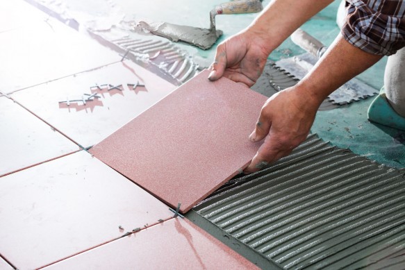 51918416 - installing tiles - professional mason